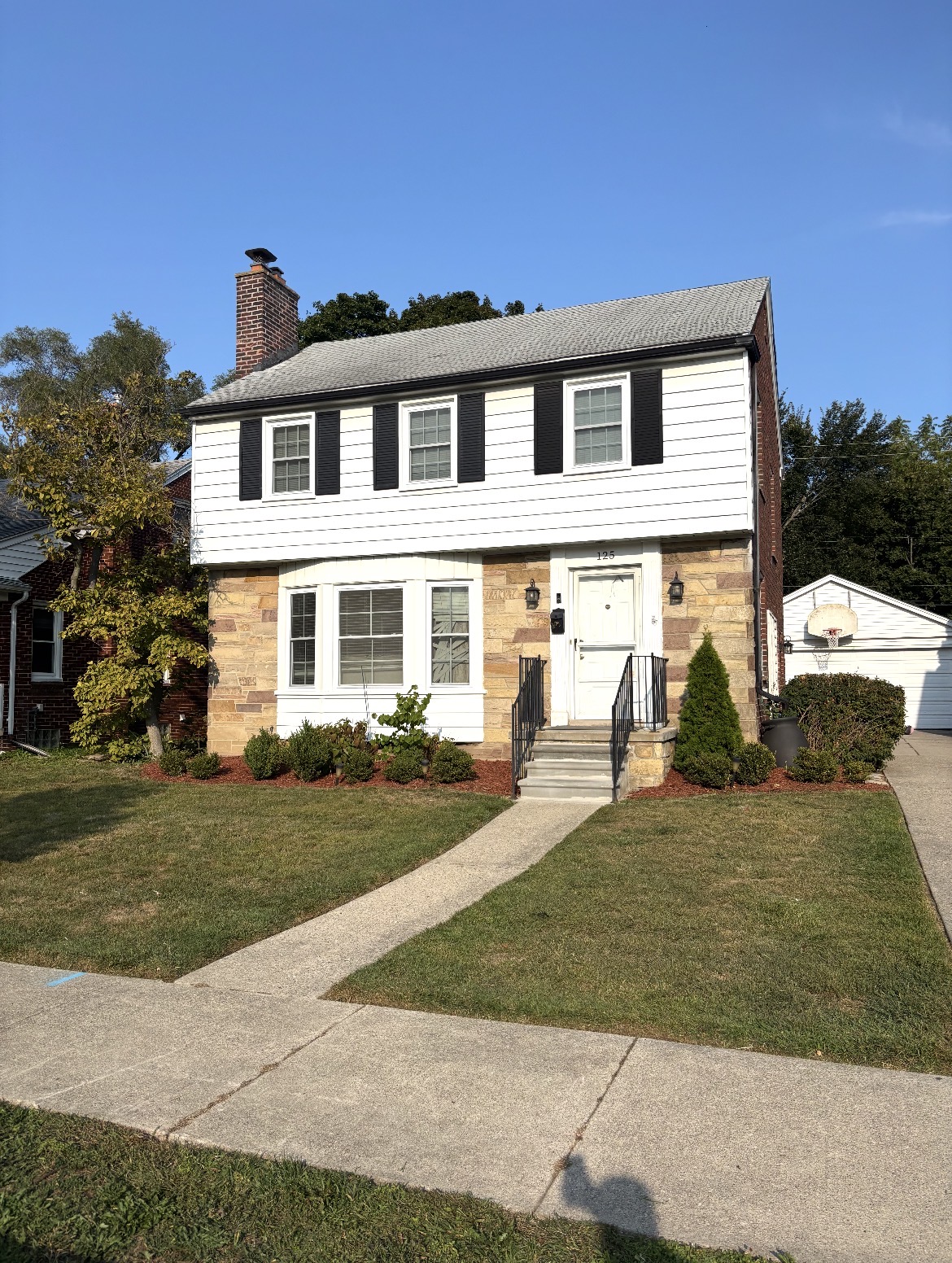 Residential home with maintained lawn and landscaping